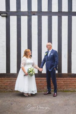 Hogarths stone manor wedding photography bride groom portrait outside tudor mansion holding hands